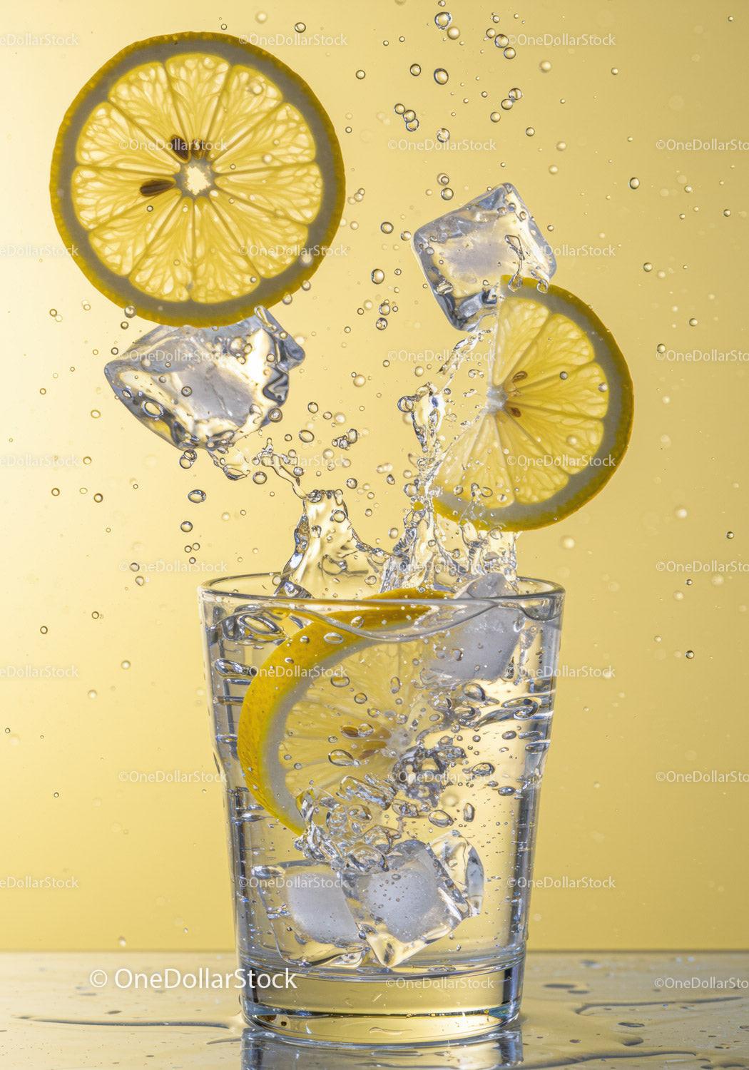 Refreshing Lemon Slices and Ice Splash in Clear Glass