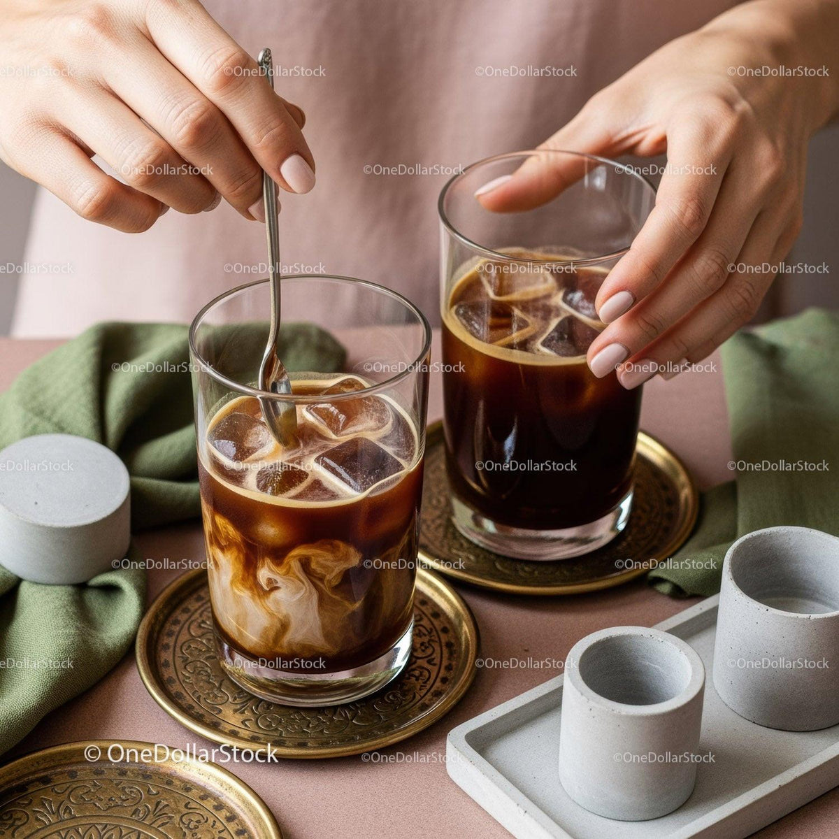 Elegant Iced Coffee Glasses with Ice and Stirred Drink in Stylish Setting