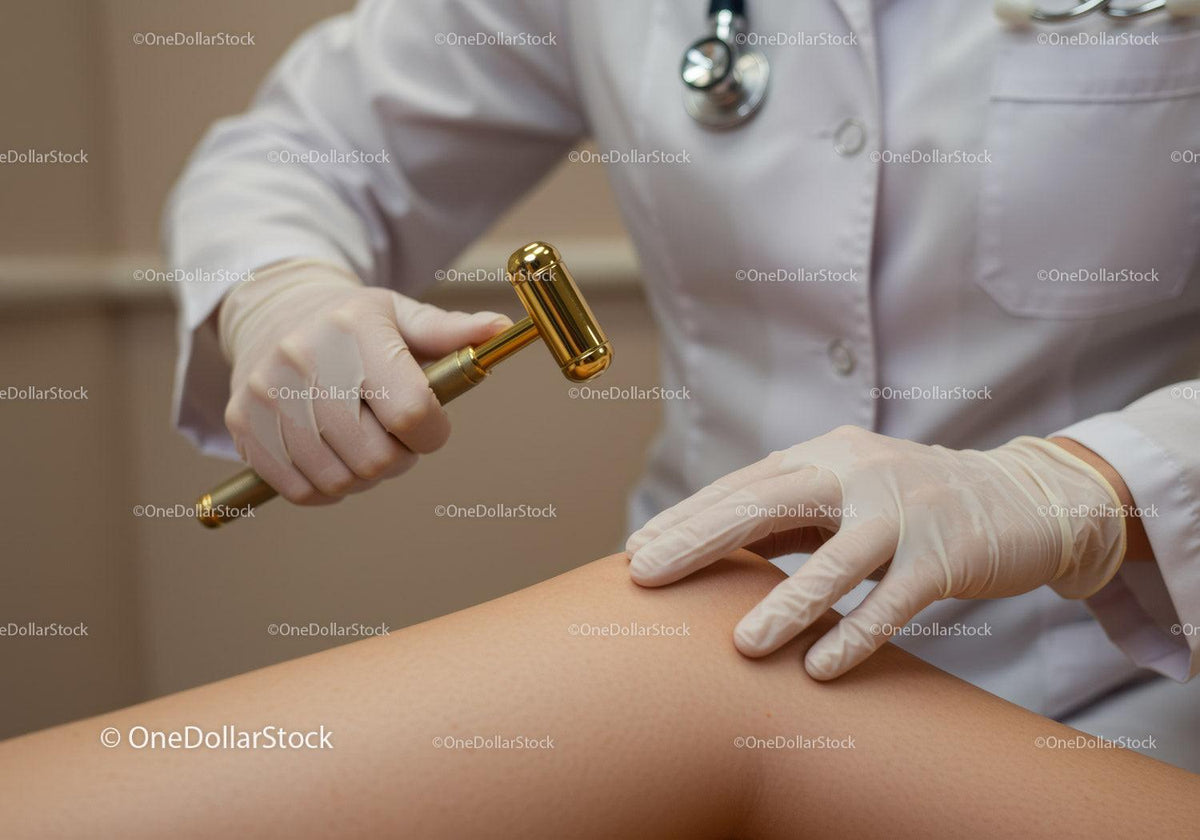 Doctor Using Reflex Hammer During Medical Examination