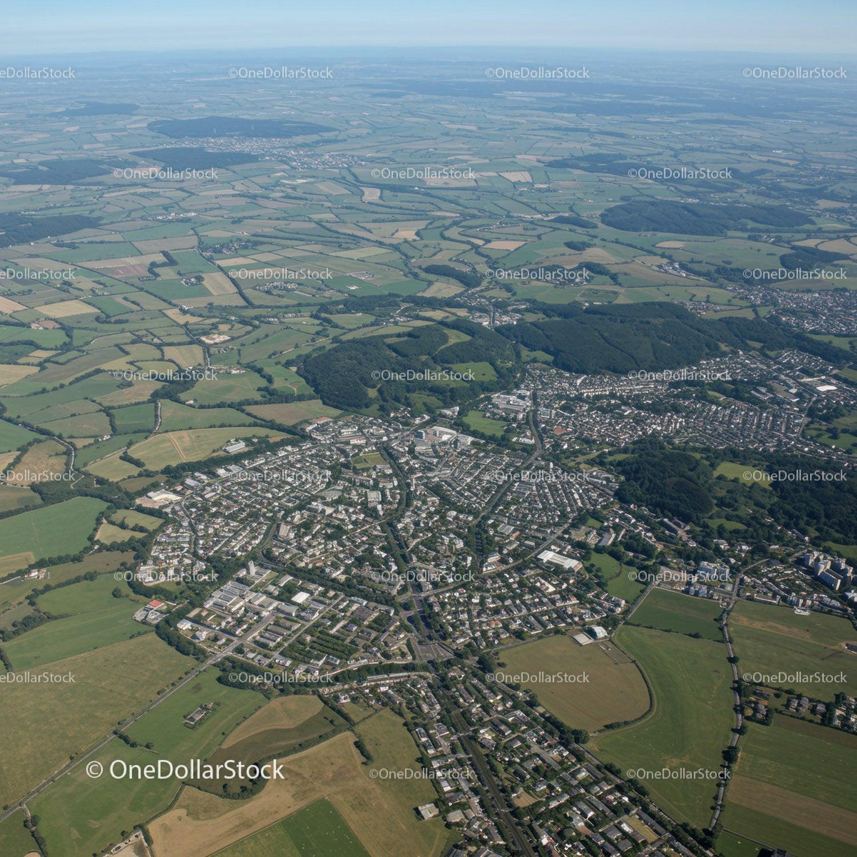 Aerial View of Suburban Town Surrounded by Fields and Green Landscape