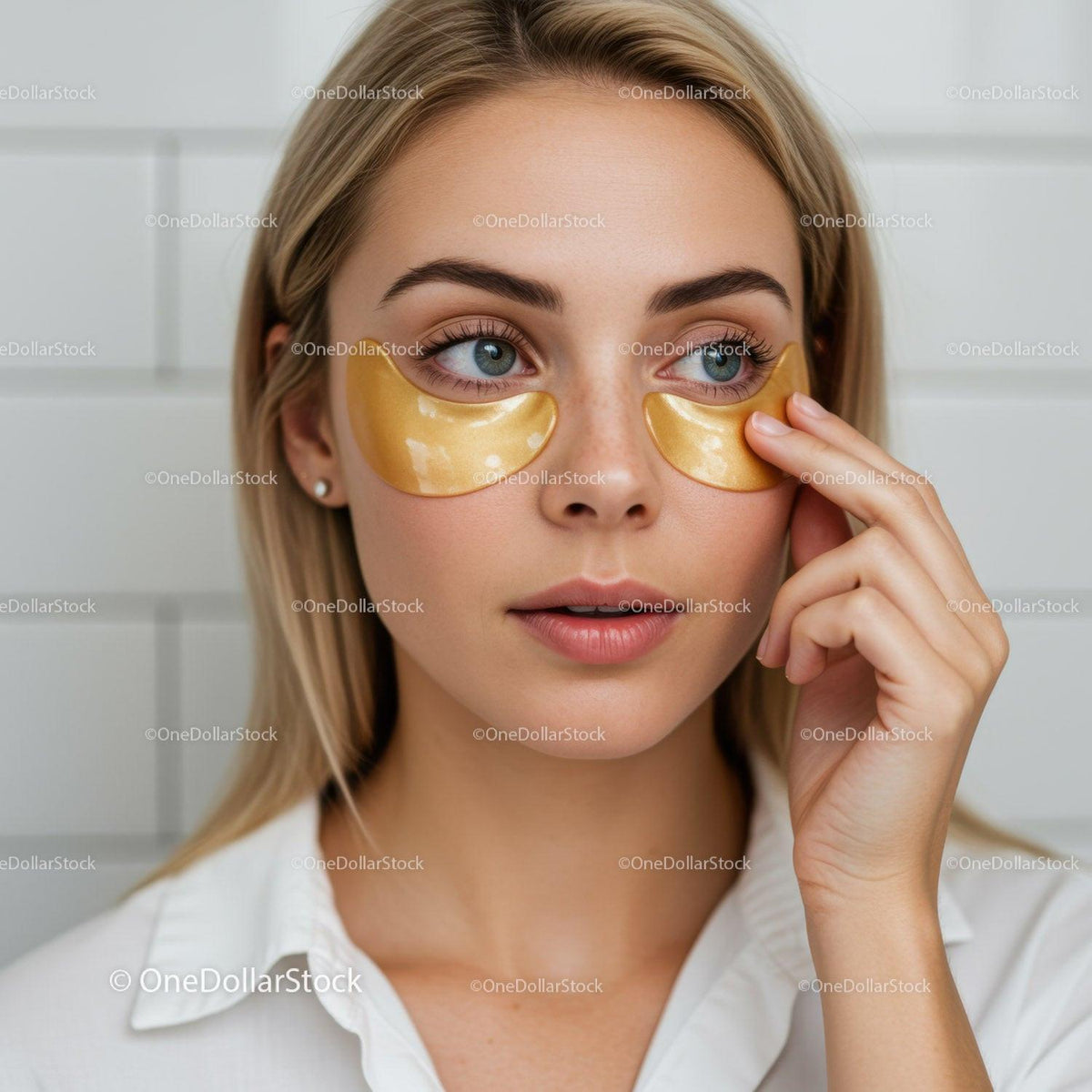 Young Woman Applying Under-Eye Gold Eye Patches for Skin Care