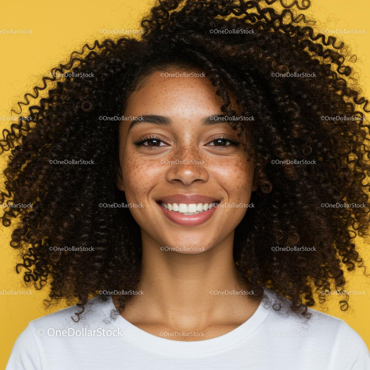 Bright Smiling Woman with Curly Hair and Freckles against Yellow Background