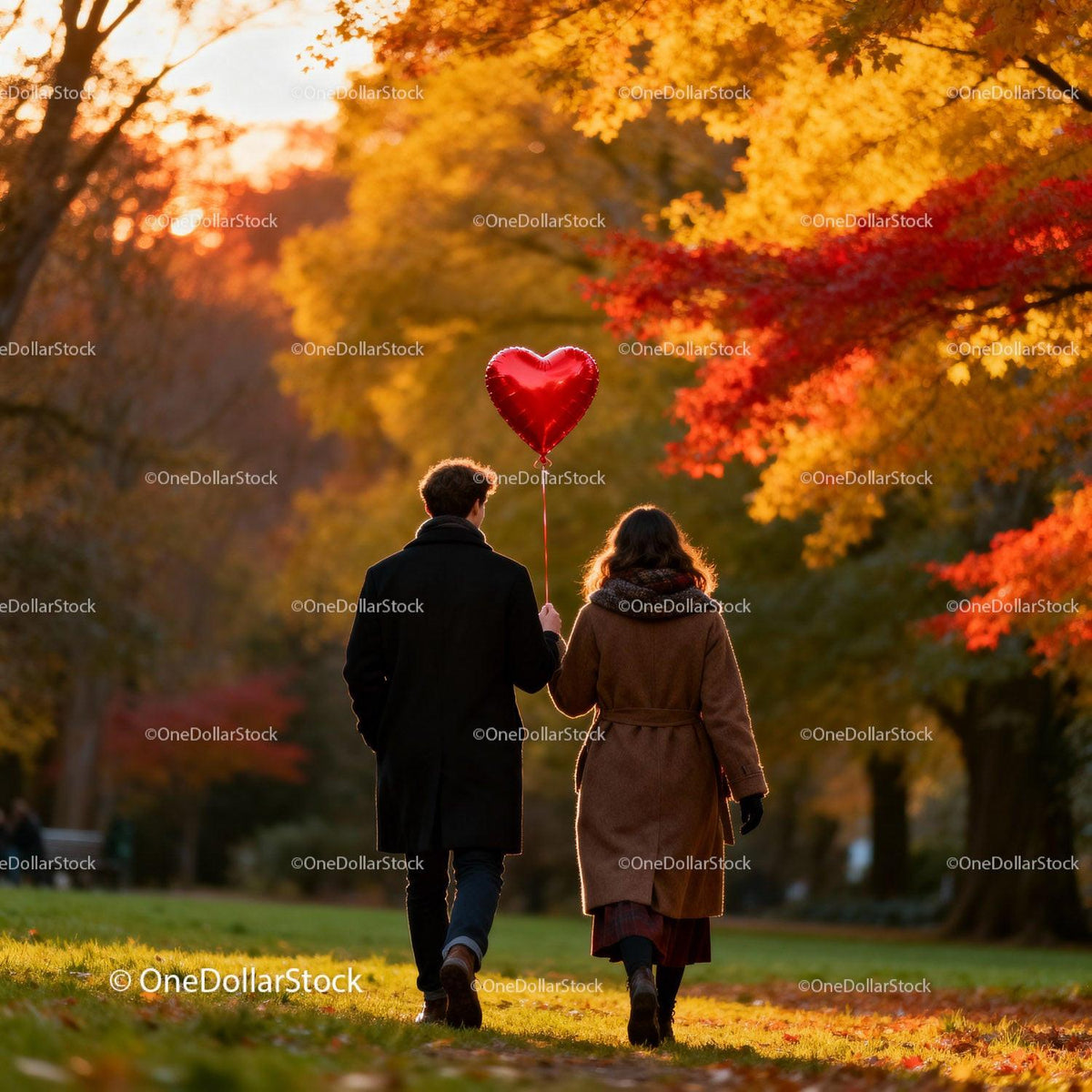 Couple walking in autumn park with heart-shaped balloon