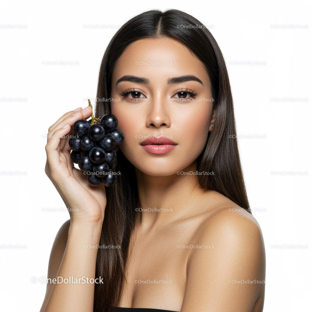 Portrait of a Beautiful Woman Holding Fresh Black Grapes in Studio