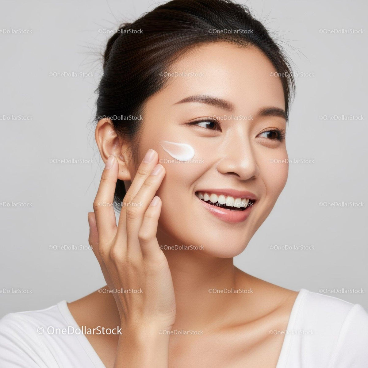 Young Woman Applying Skincare Cream for Radiant Skin