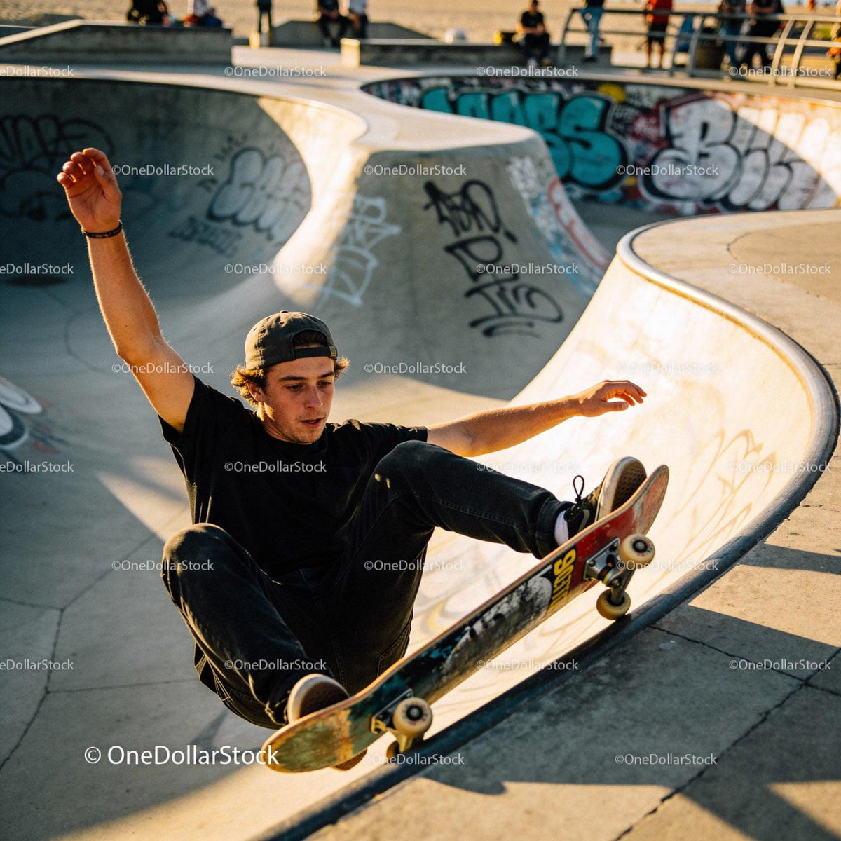 Young skater performing tricks in urban skatepark
