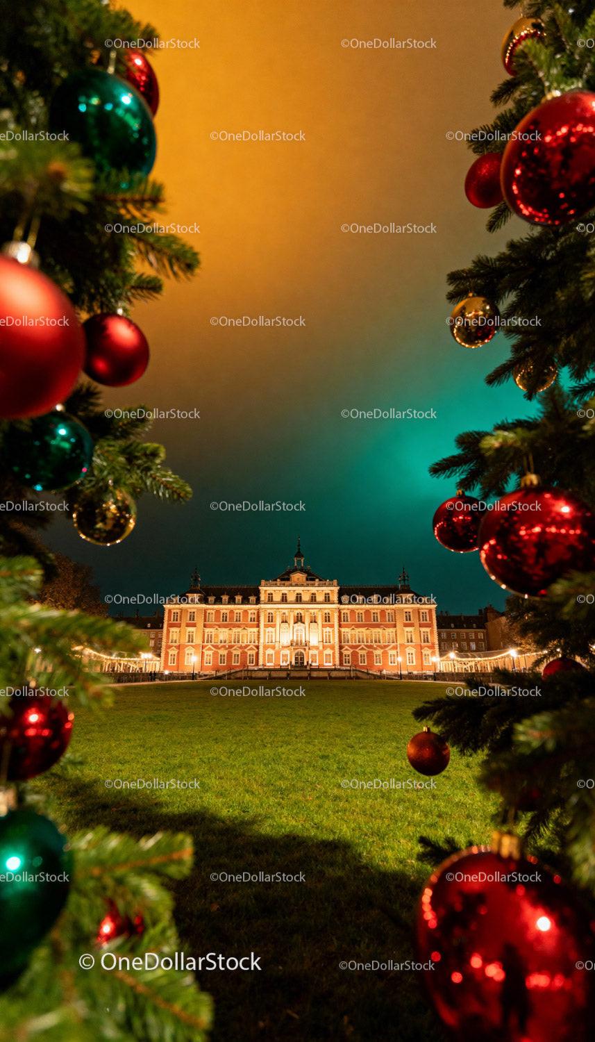 Historic building framed by decorated Christmas trees