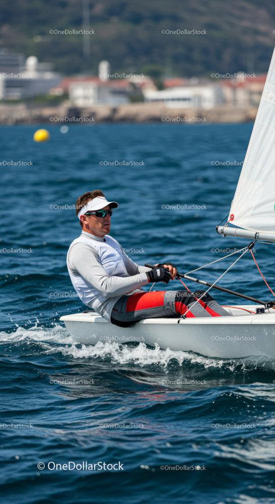 Man Sailing a Small Yacht in Blue Ocean Water Stock Photo Bundle preview