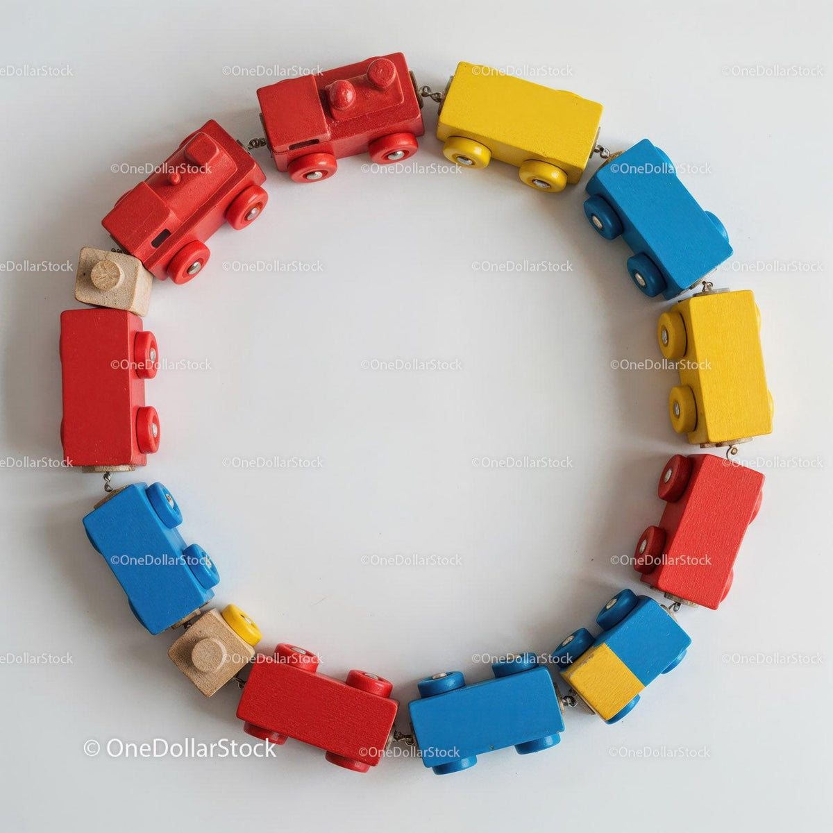 Colorful wooden toy train cars in red, blue, yellow, and natural wood arranged in a circle