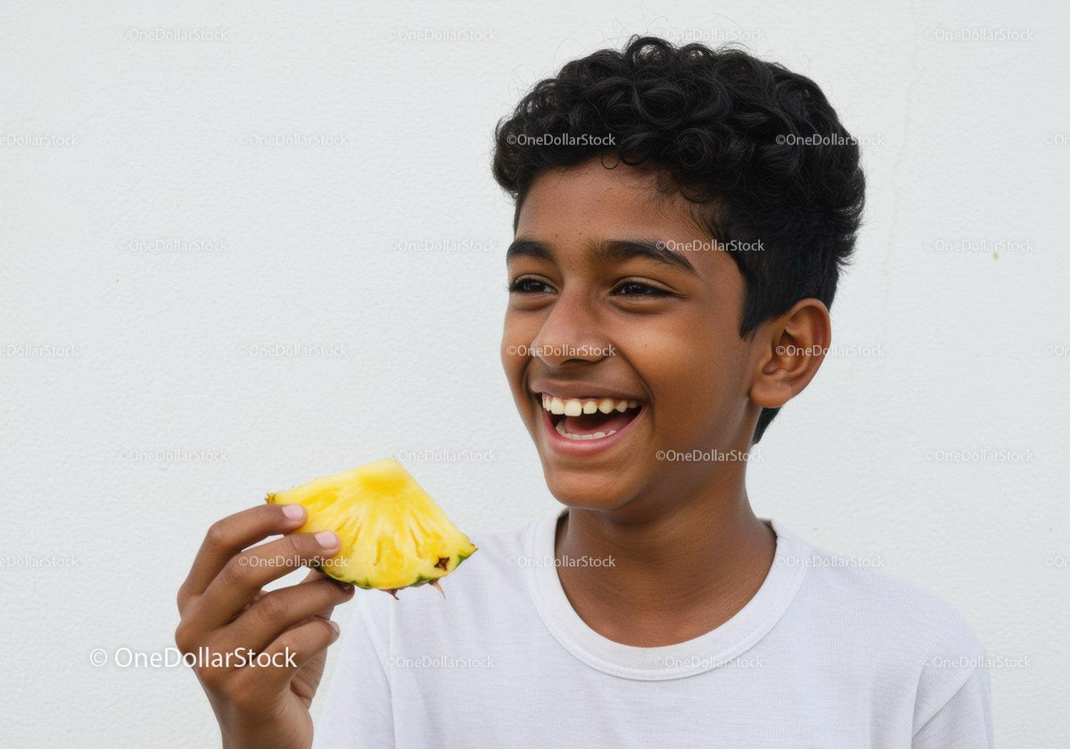 Joyful Young Boy Enjoying Pineapple Slice with Bright Smile