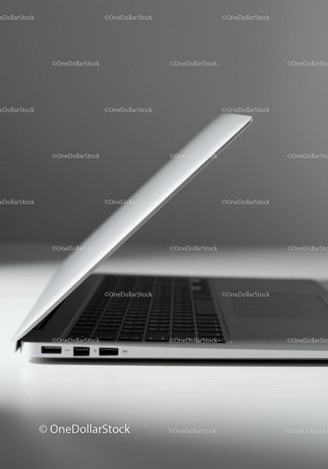 Minimalist Silver Laptop with Keyboard on White Surface