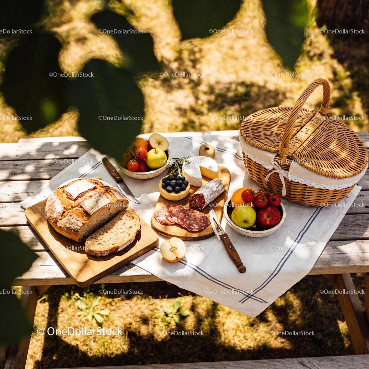 Rustic Picnic Table with Fresh Bread and Cheese Spread