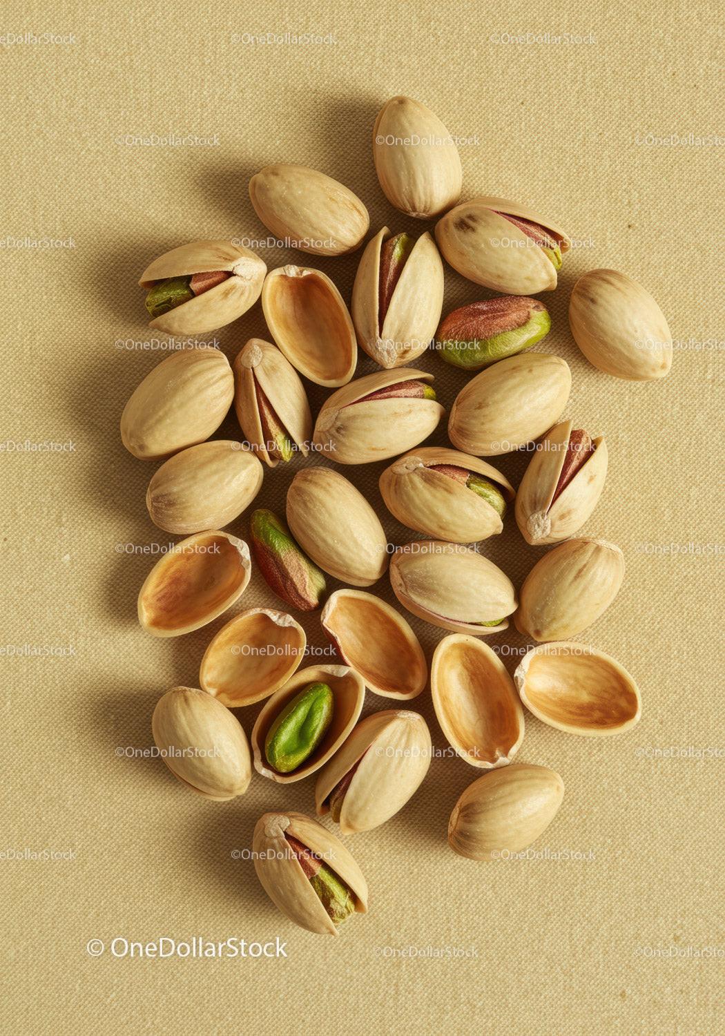 Close up of pistachio nuts on textured fabric background