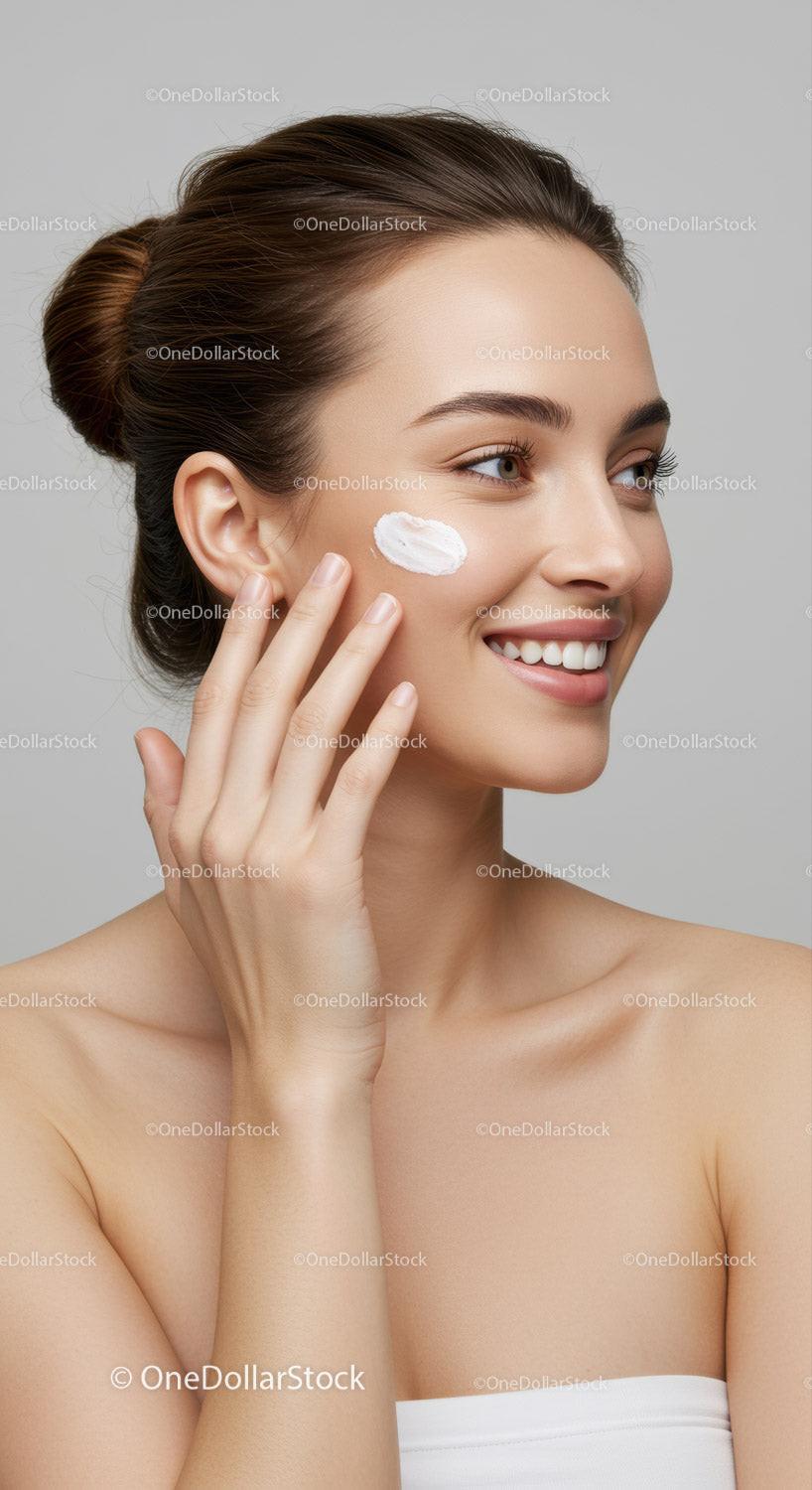 Portrait of a Smiling Woman Applying Cream on Her Cheek for Skincare
