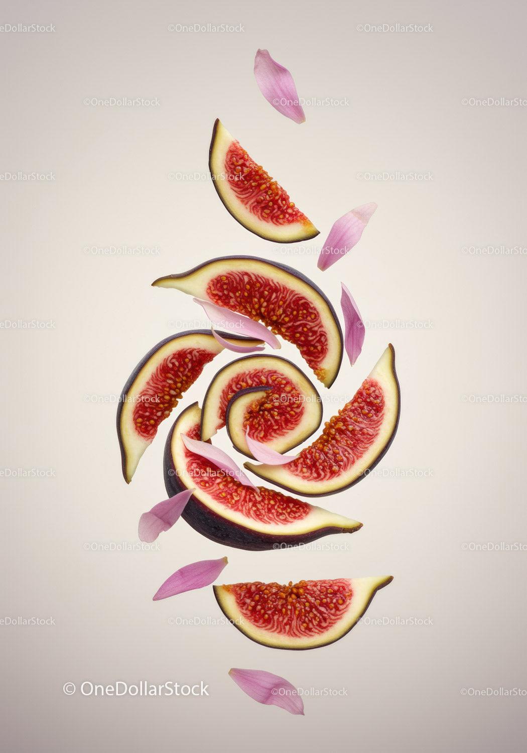 Fresh sliced figs with pink flower petals on beige
