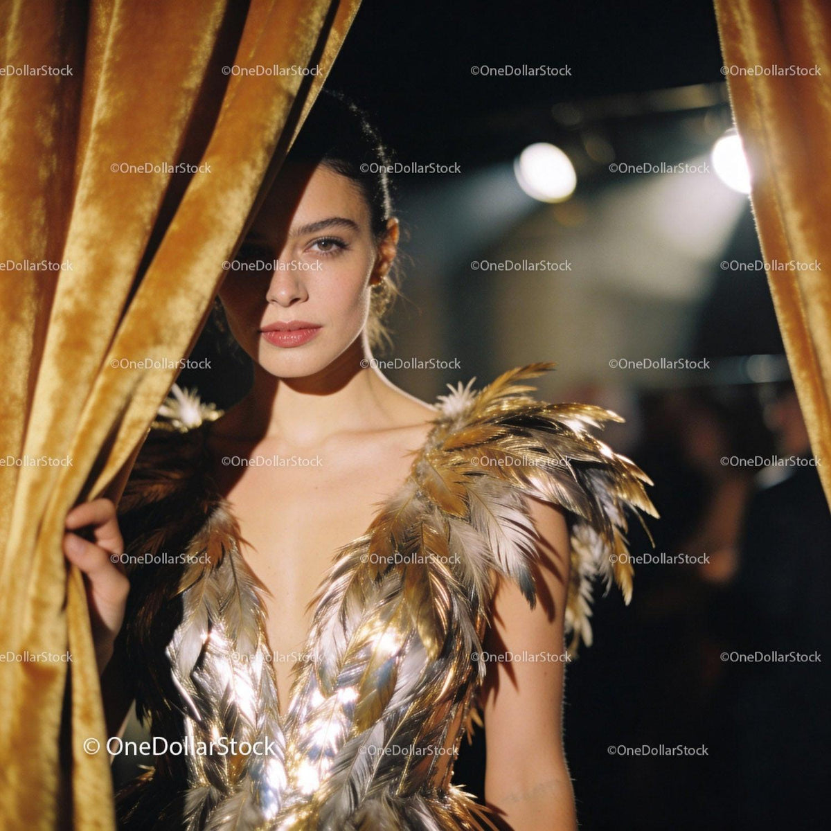 Elegant woman in gold feathered dress backstage