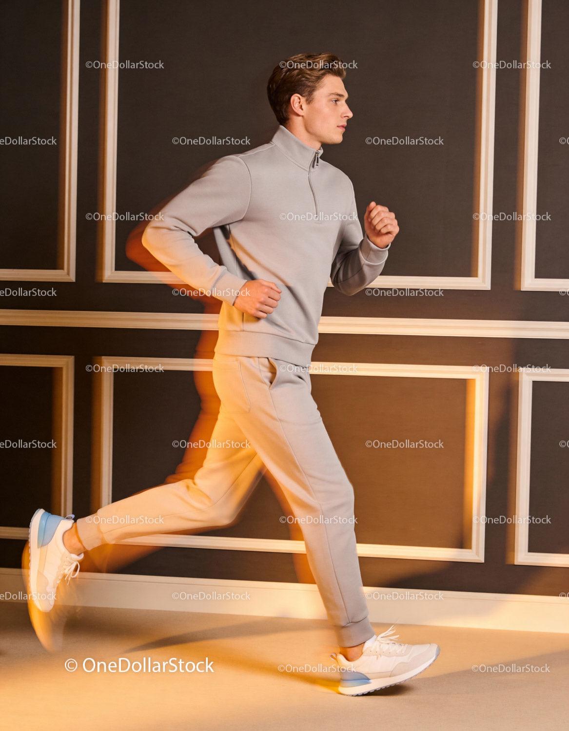 Young man jogging indoors in modern casual sportswear