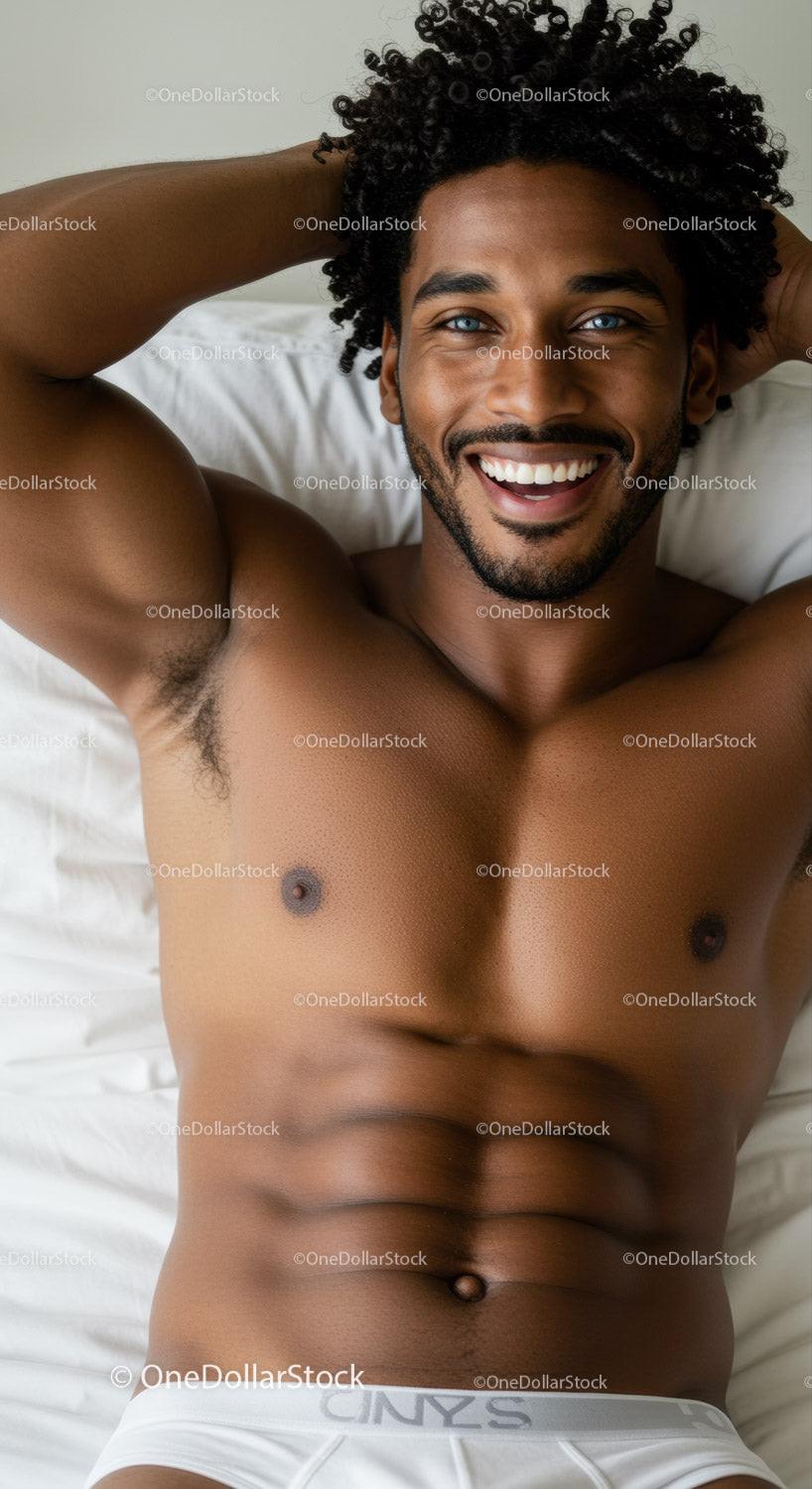 Smiling man relaxing on bed with bright blue eyes