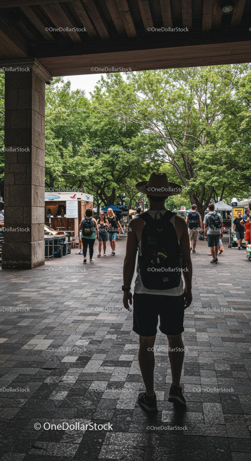 Traveler with Hat Exploring Vibrant Outdoor Market