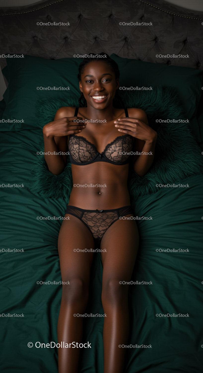 Smiling woman relaxing on bed in elegant lingerie set