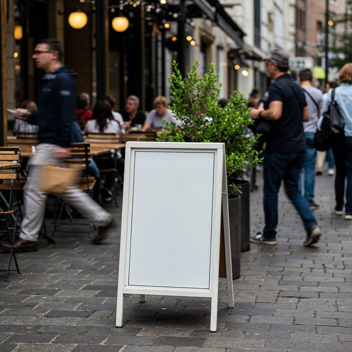 Blank sidewalk sign outside busy urban cafe JPG Mockup Image preview