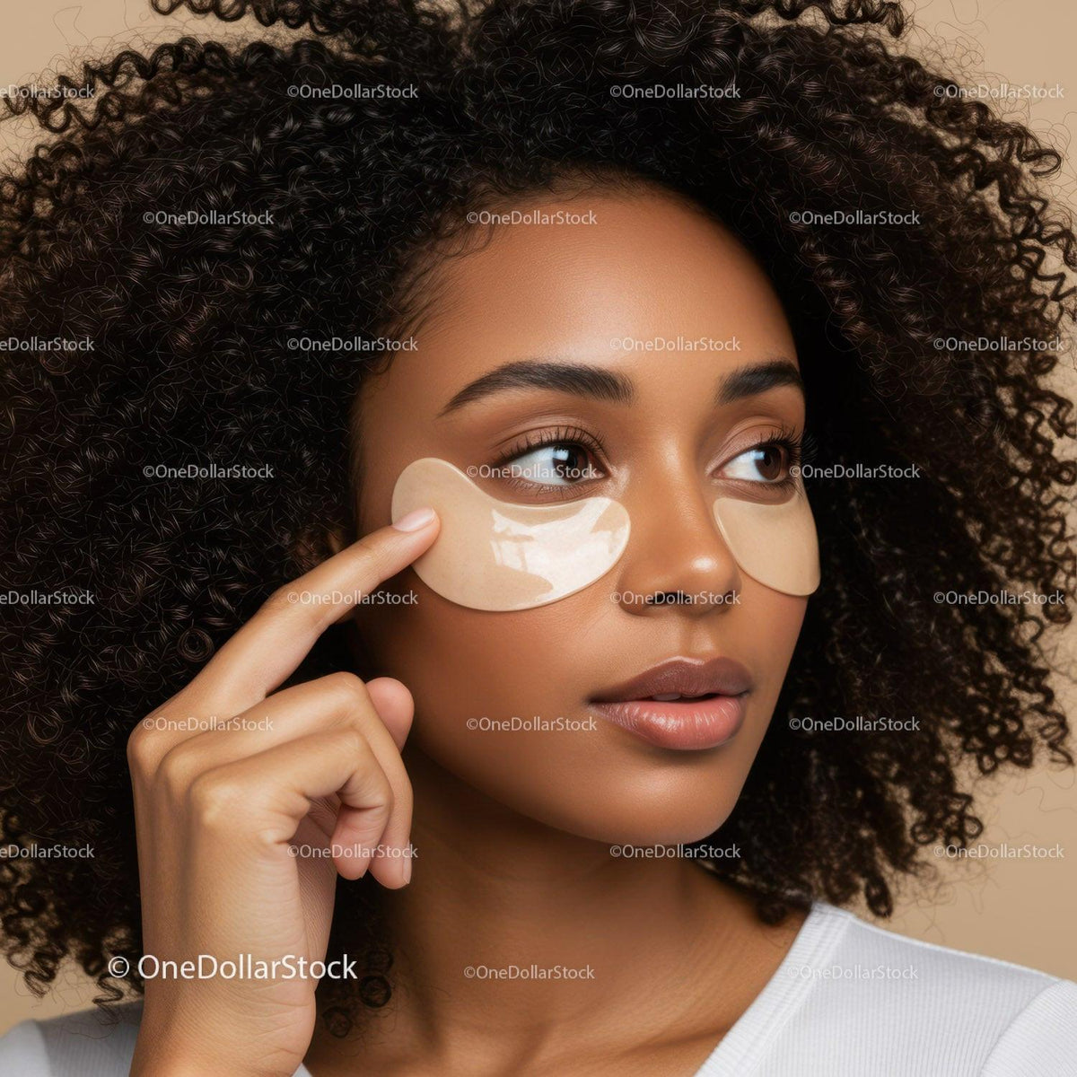 Woman with Curly Hair Applying Eye Patches for Skincare Routine