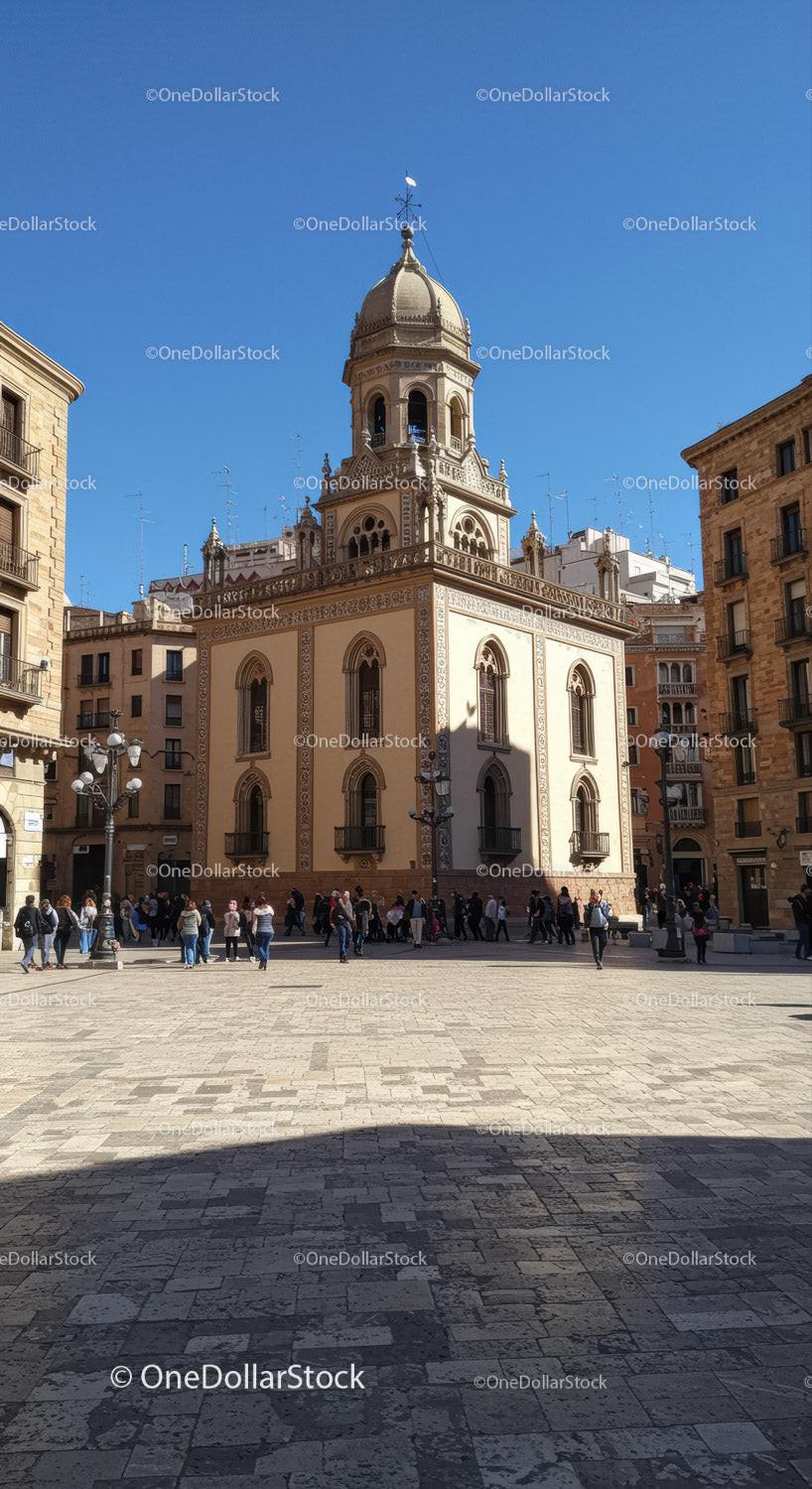 Baroque Church Tower in European City Square with Crowds