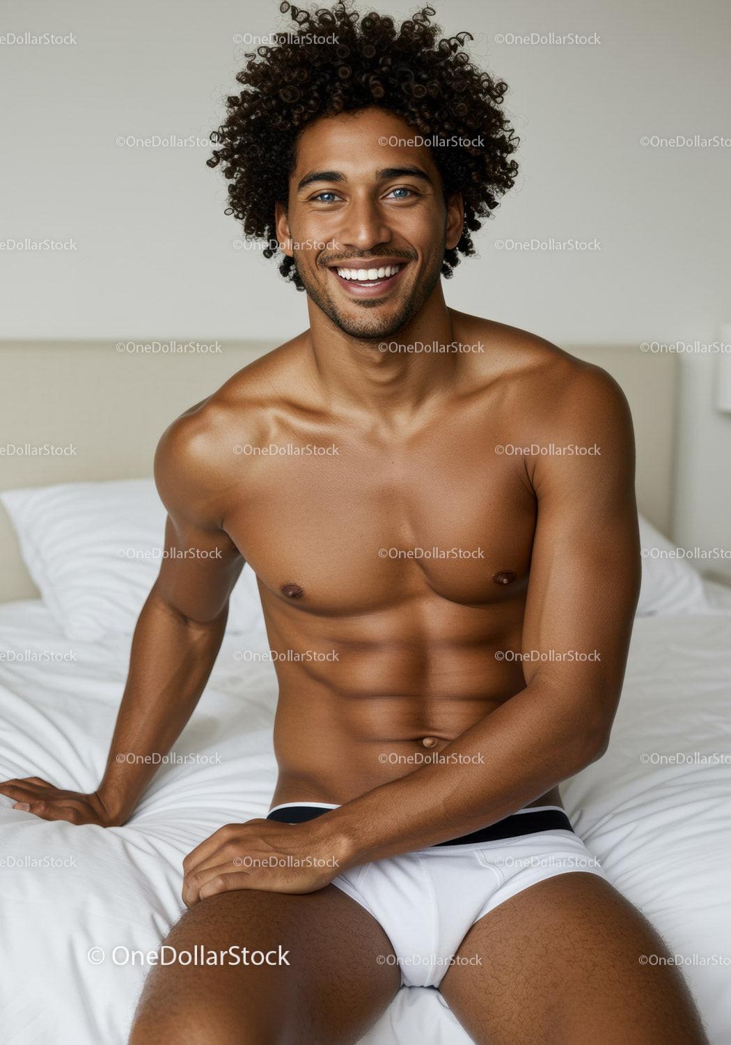 Happy young man relaxing on bed in comfortable underwear