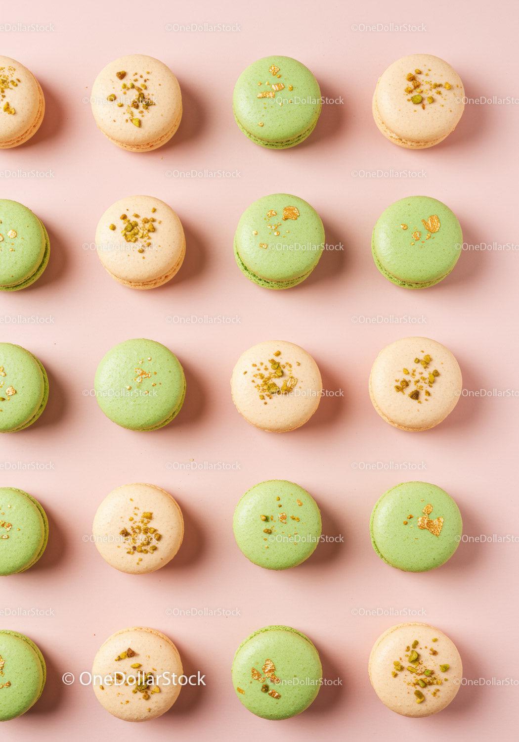 Assorted pistachio and vanilla macarons on pastel background
