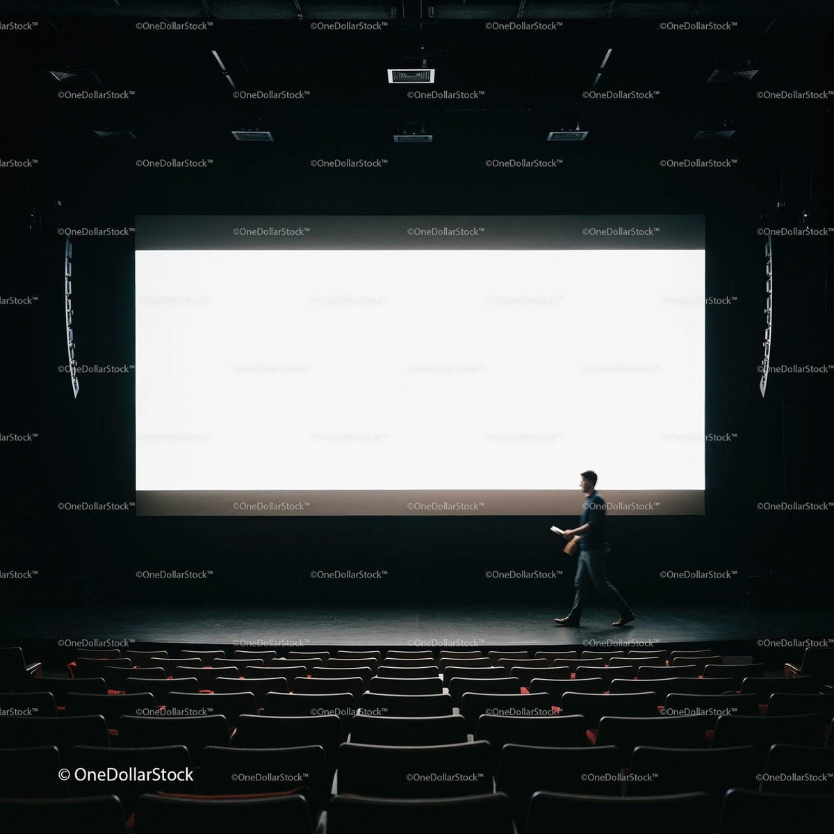 Man Walking Across Dark Theater Stage With Large Screen JPG Mockup Image preview