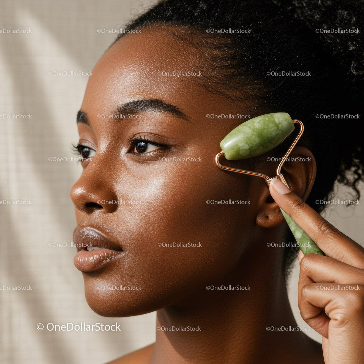 African American Woman Using Jade Roller for Facial Massage and Skin Care