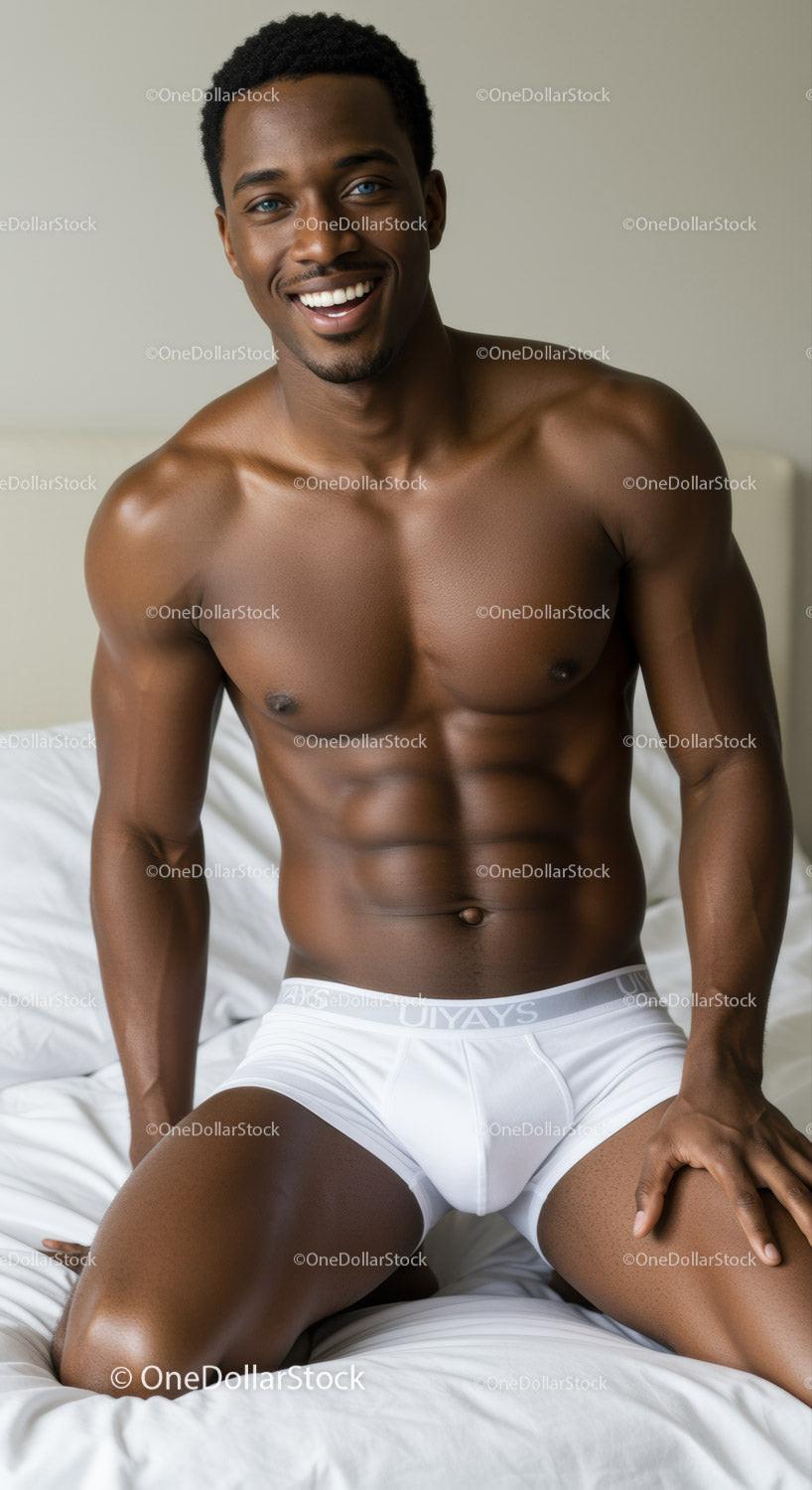 Smiling muscular man in white underwear on bed
