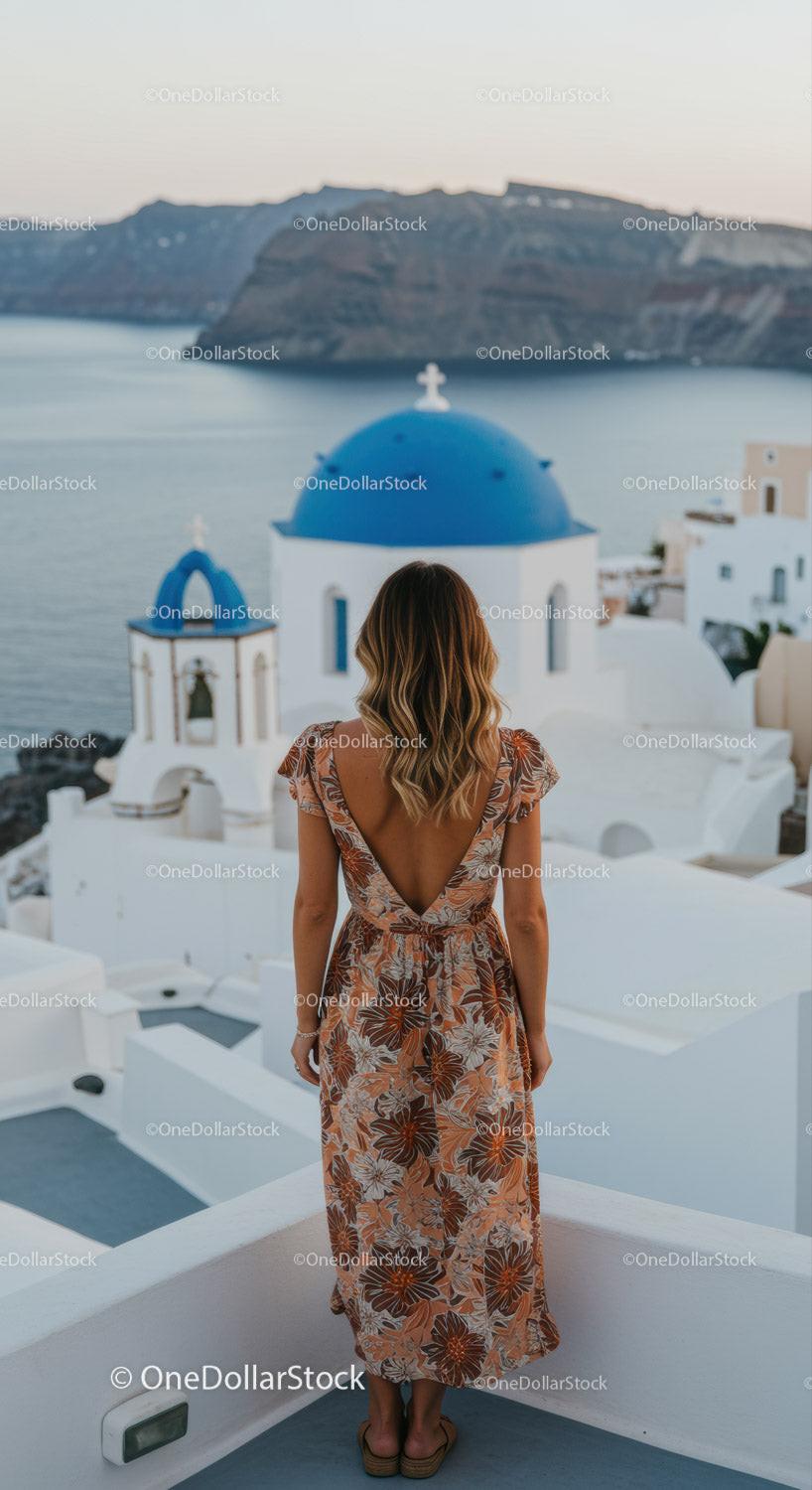 Woman with floral dress overlooking Santorini sea view