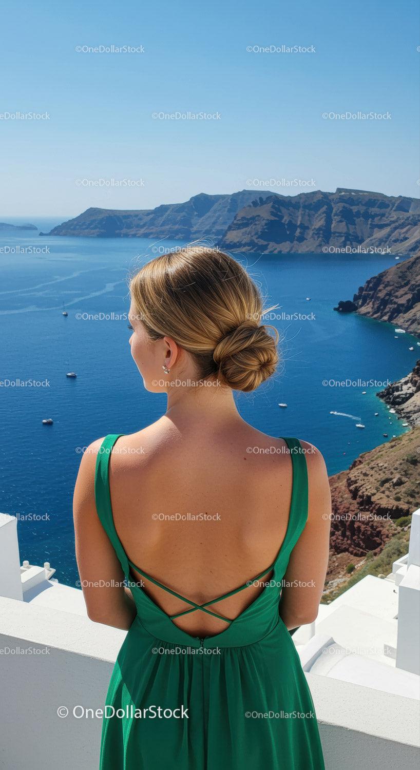 Woman in Green Dress Overlooking Serene Coastal Cliffs