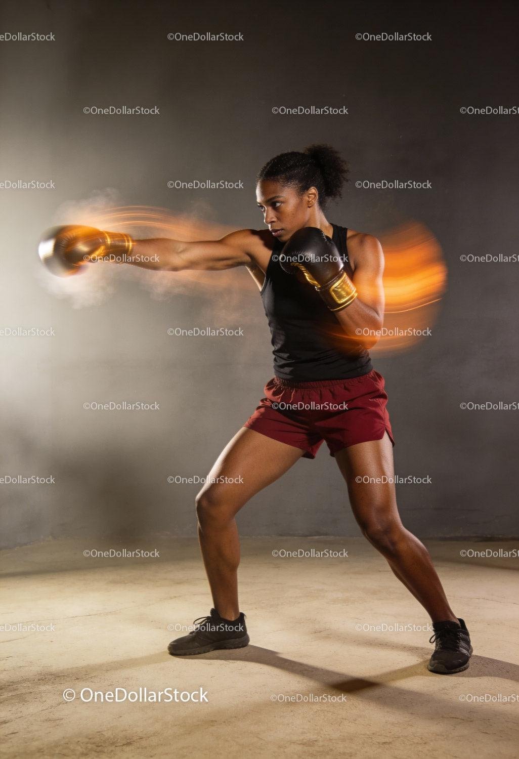 Focused female boxer delivering a powerful punch