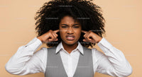 Frustrated Woman Covering Ears with Annoyed Expression
