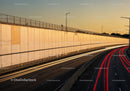 Urban Highway with Light Trails and Sunset Sky