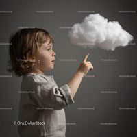Curious toddler reaching toward a fluffy cloud indoors