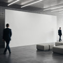 Businessmen walking in modern minimalist lobby with blank wall