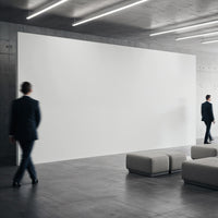 Businessmen walking in modern minimalist lobby with blank wall