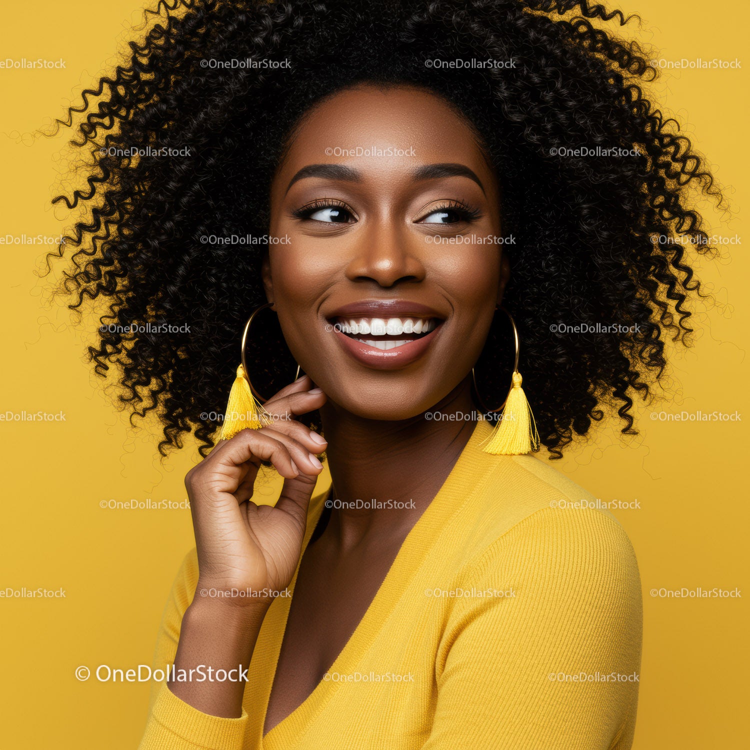 Smiling Woman with Curly Hair Wearing Yellow Clothing in Bright Studio