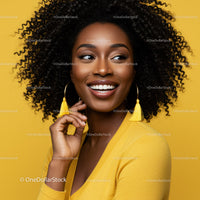 Smiling Woman with Curly Hair Wearing Yellow Clothing in Bright Studio