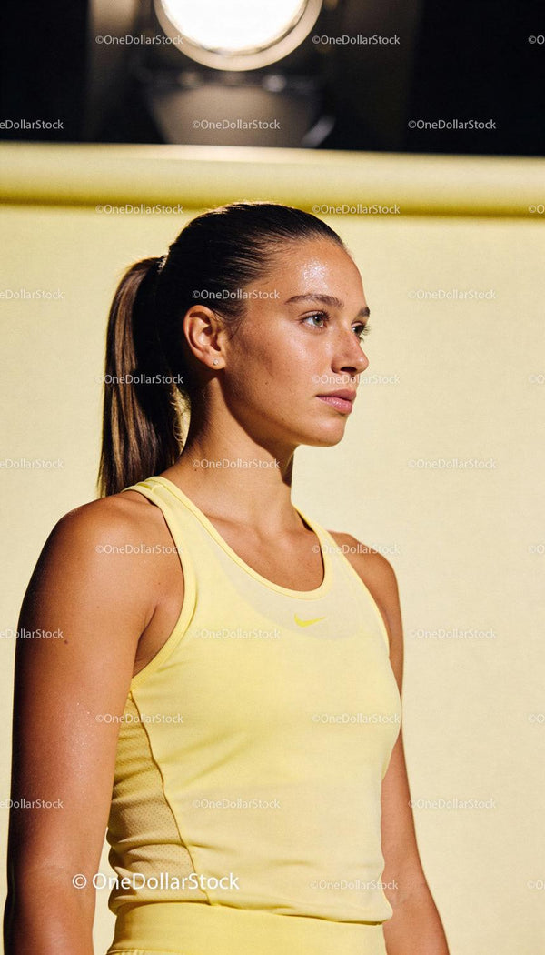 Focused young woman in yellow sportswear during training