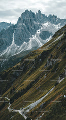 Majestic Rocky Mountain Peaks with Green Slopes and Snow Patches