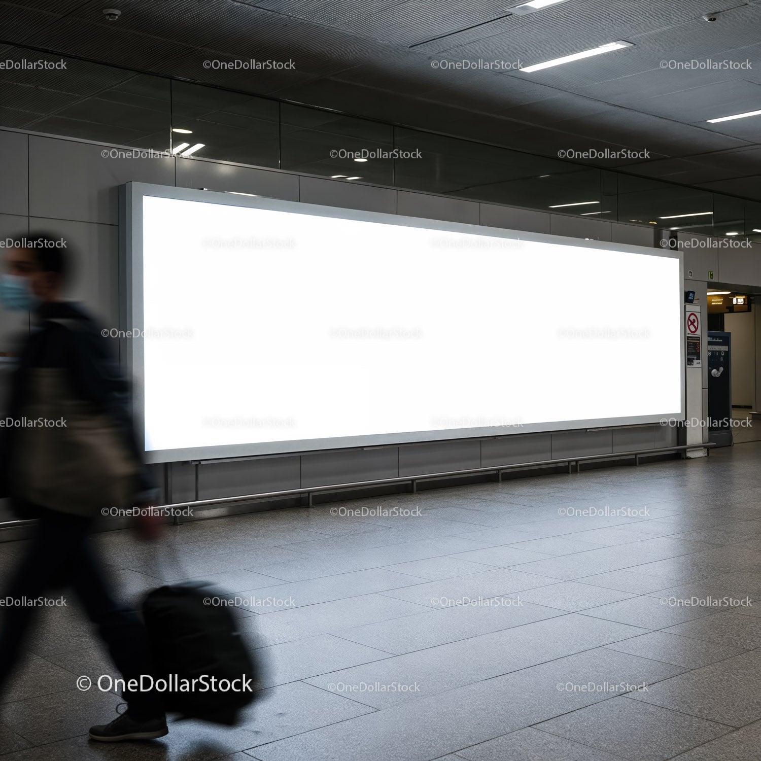 Traveler walking past large blank airport billboard