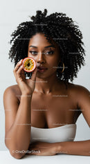 Elegant Portrait of a Woman with Curly Hair Holding Passion Fruit
