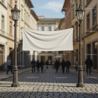Blank banner hanging between vintage street lamps in city