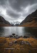 Majestic Mountain Lake with Snow-Capped Peaks and Dramatic Clouds