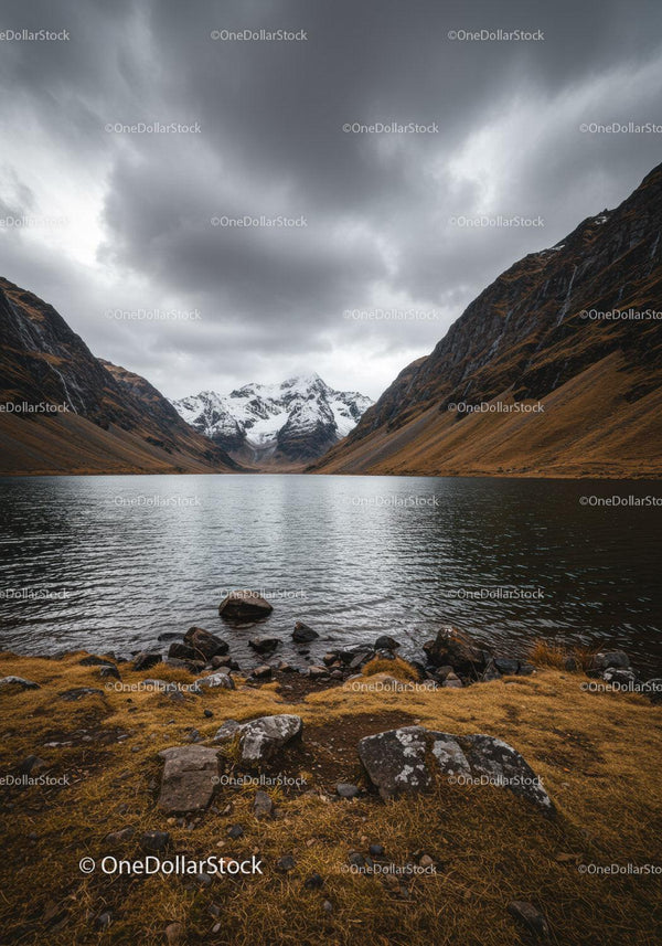 Majestic Mountain Lake with Snow-Capped Peaks and Dramatic Clouds