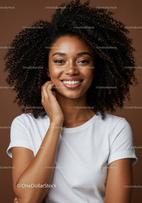 Portrait of a Smiling Woman with Curly Hair in Casual Attire